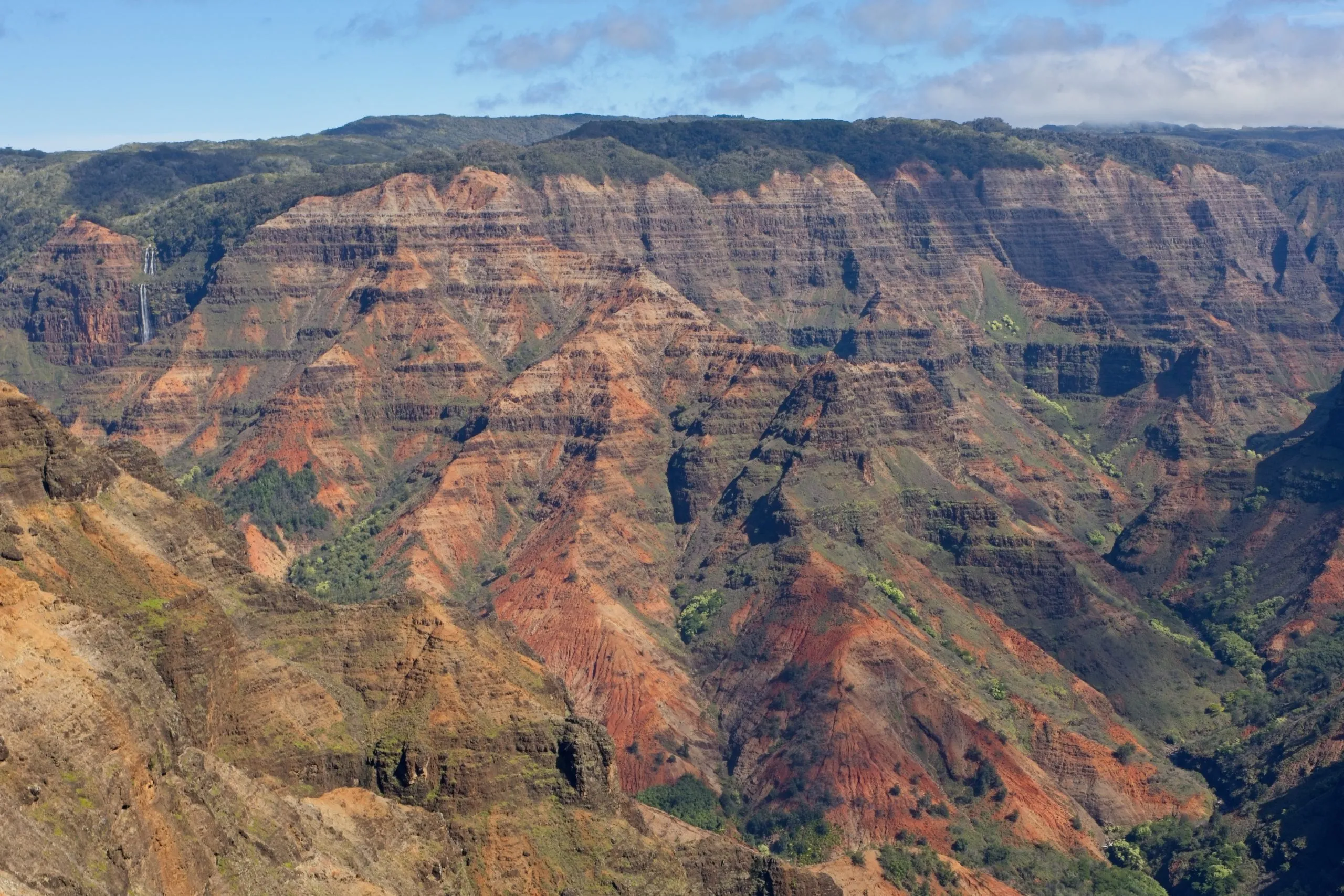 Waimea Canyon with layered red and green cliffs on Kauai, Hawaii.