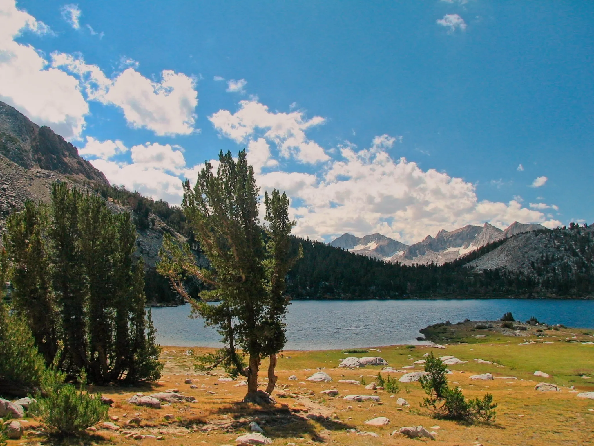 Lake Virginia with pine trees and granite peaks in the John Muir Wilderness.