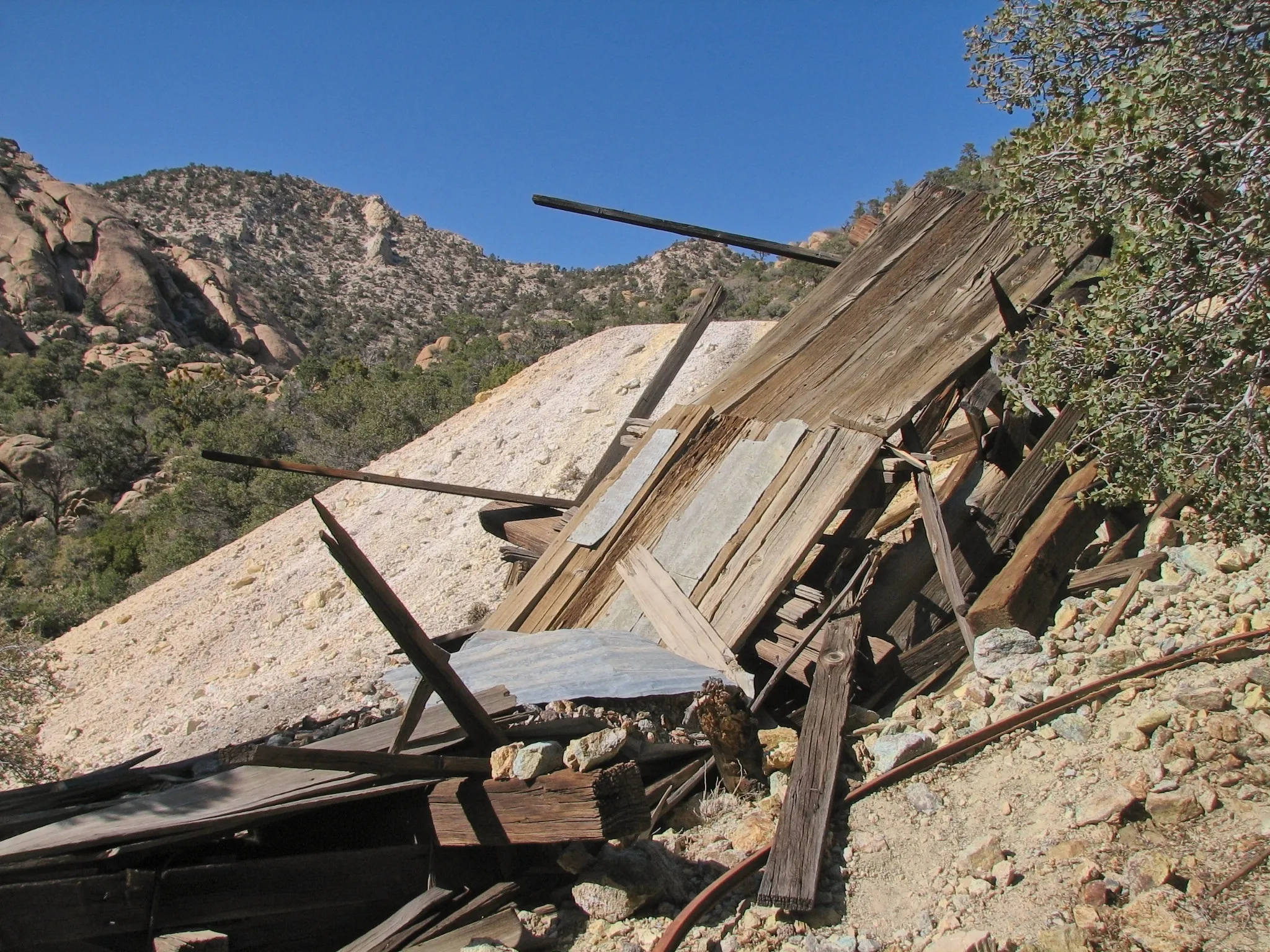 Abandoned copper mine adits, timber supports, and ore chutes at Giant Ledge Mine in Caruthers Canyon, Mojave National Preserve, California.