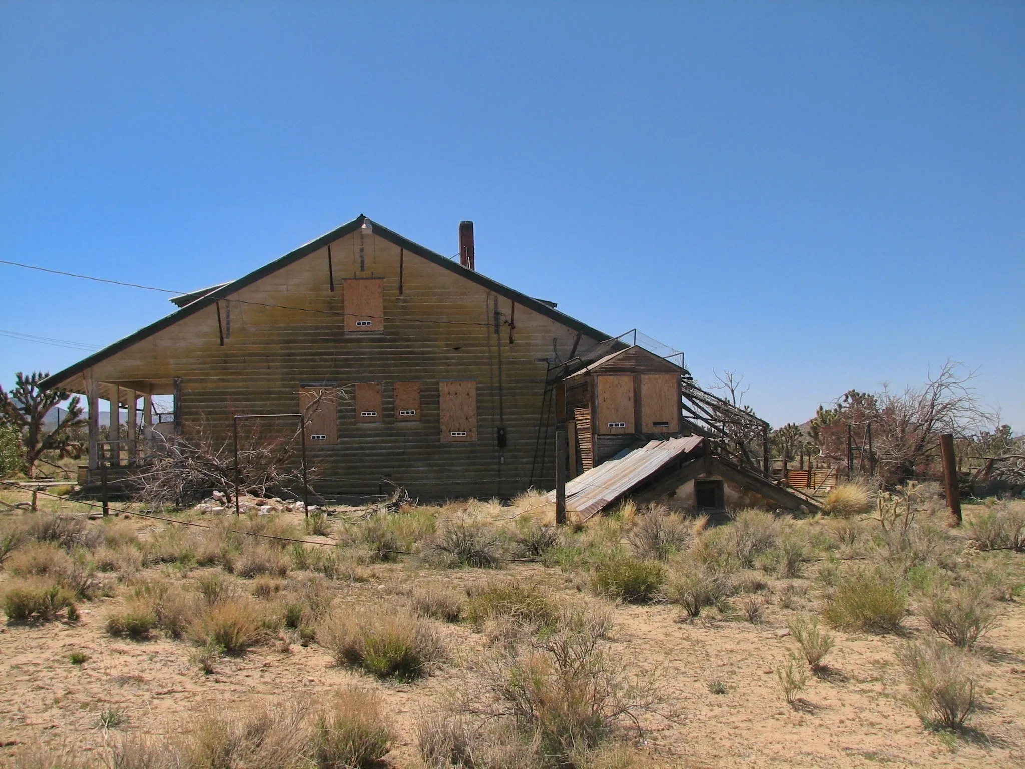 Two-story wooden mine building with boarded windows at Death Valley Mine.