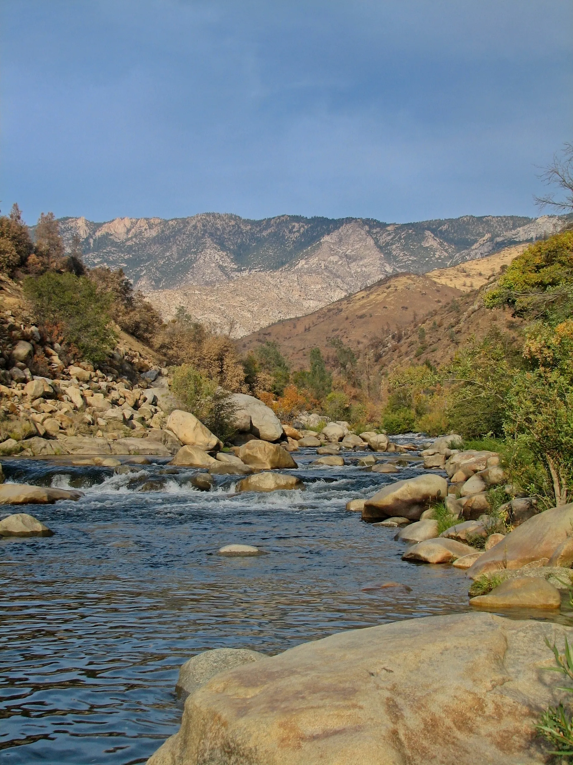 Kern River rapids flowing through a rocky canyon toward granite peaks.