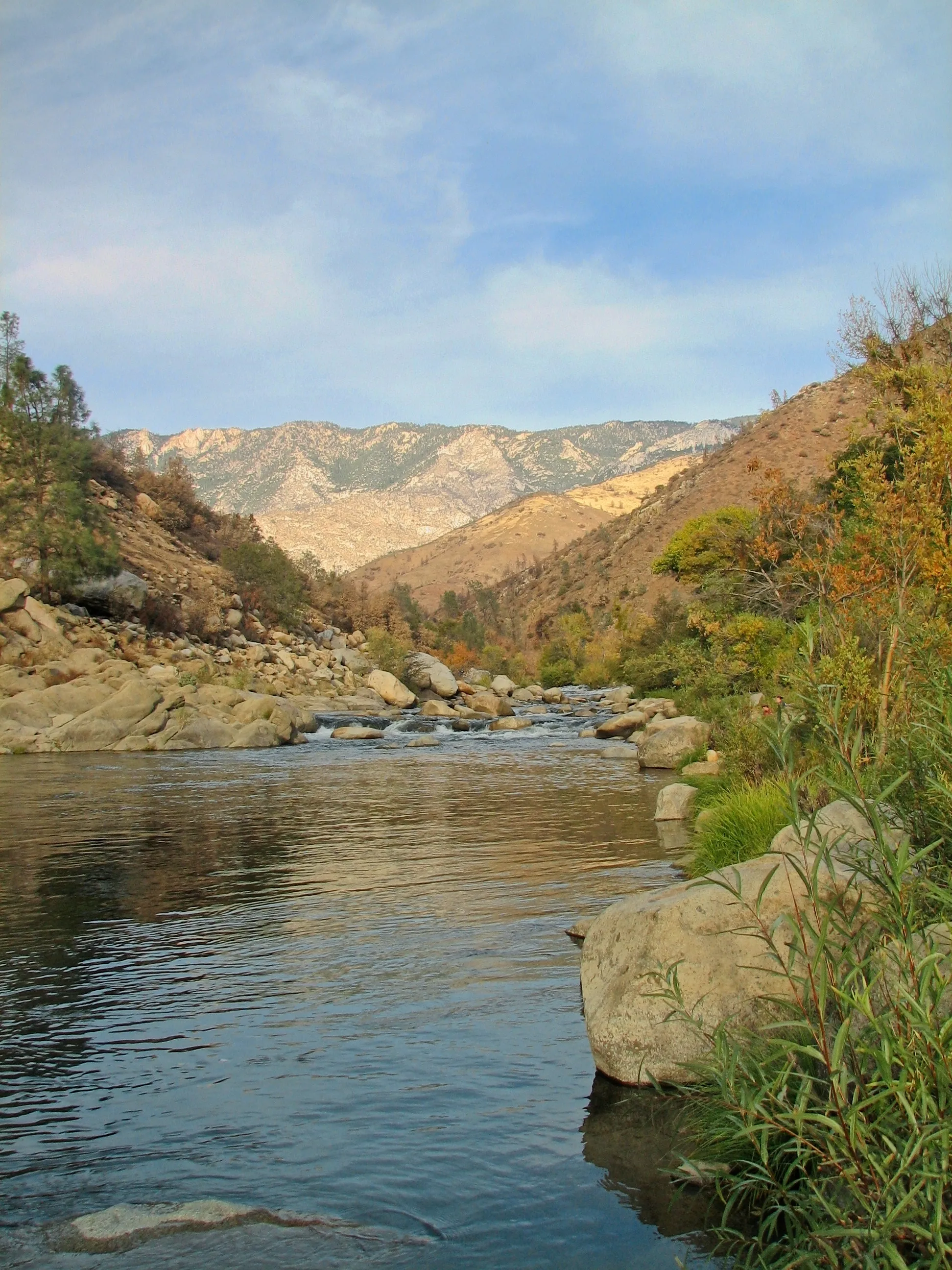 Kern River winding through a canyon with sunlit granite mountains ahead.