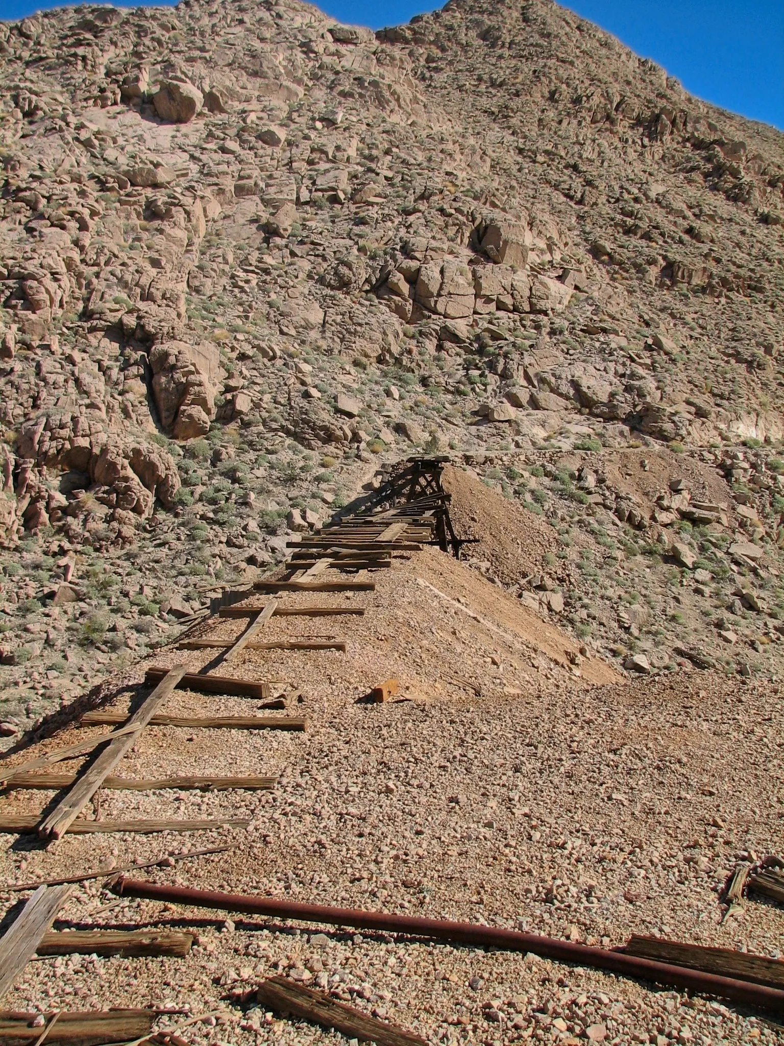 Weathered mine track ascending rocky hillside to mine entrance at War Eagle Mine.