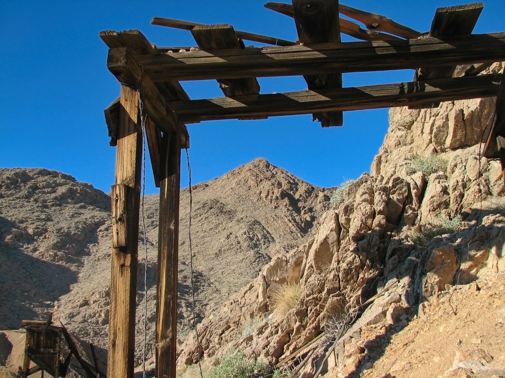 Mountain peak framed by broken wooden mine timbers at War Eagle Mine.
