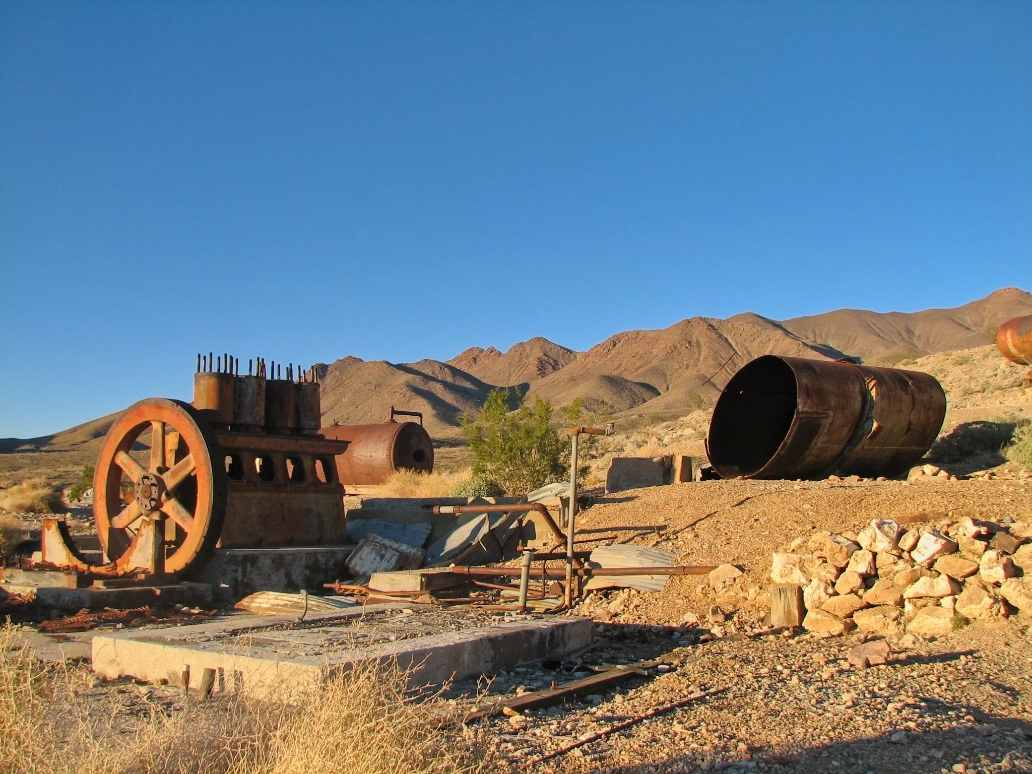 Rusted engine and horizontal tank on concrete foundations at War Eagle Mine.