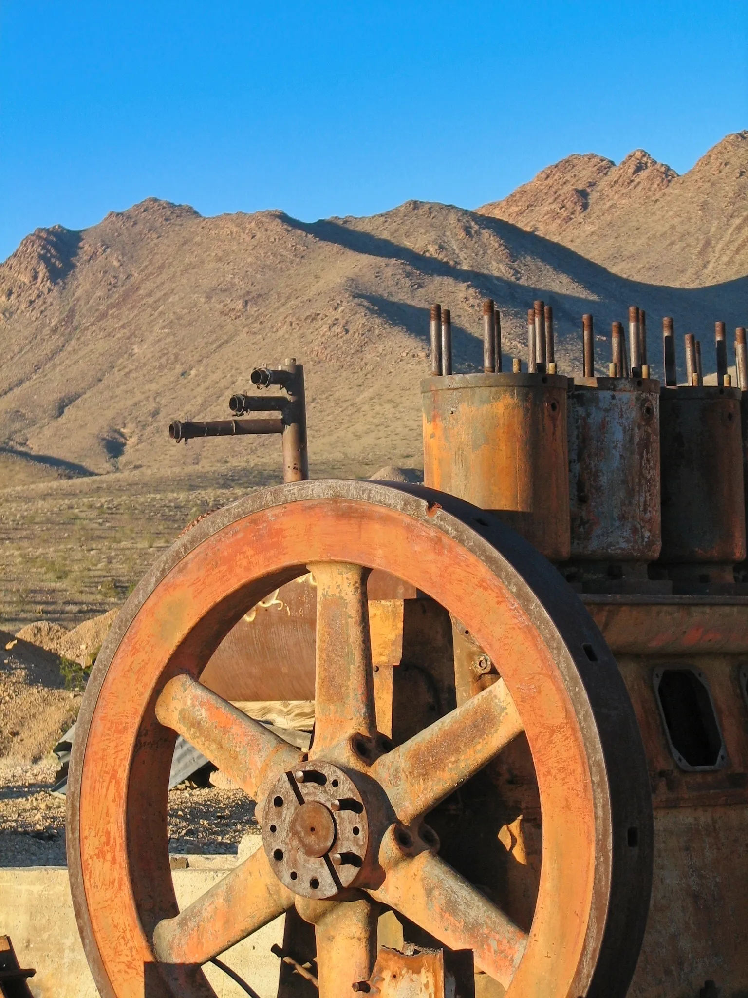 Heavily rusted mine engine with large flywheel at War Eagle Mine.