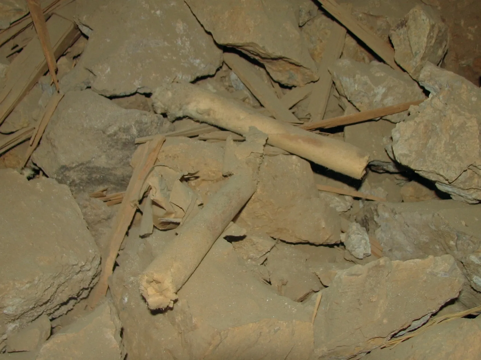 Dusty dynamite sticks among rocks inside mine at War Eagle Mine.
