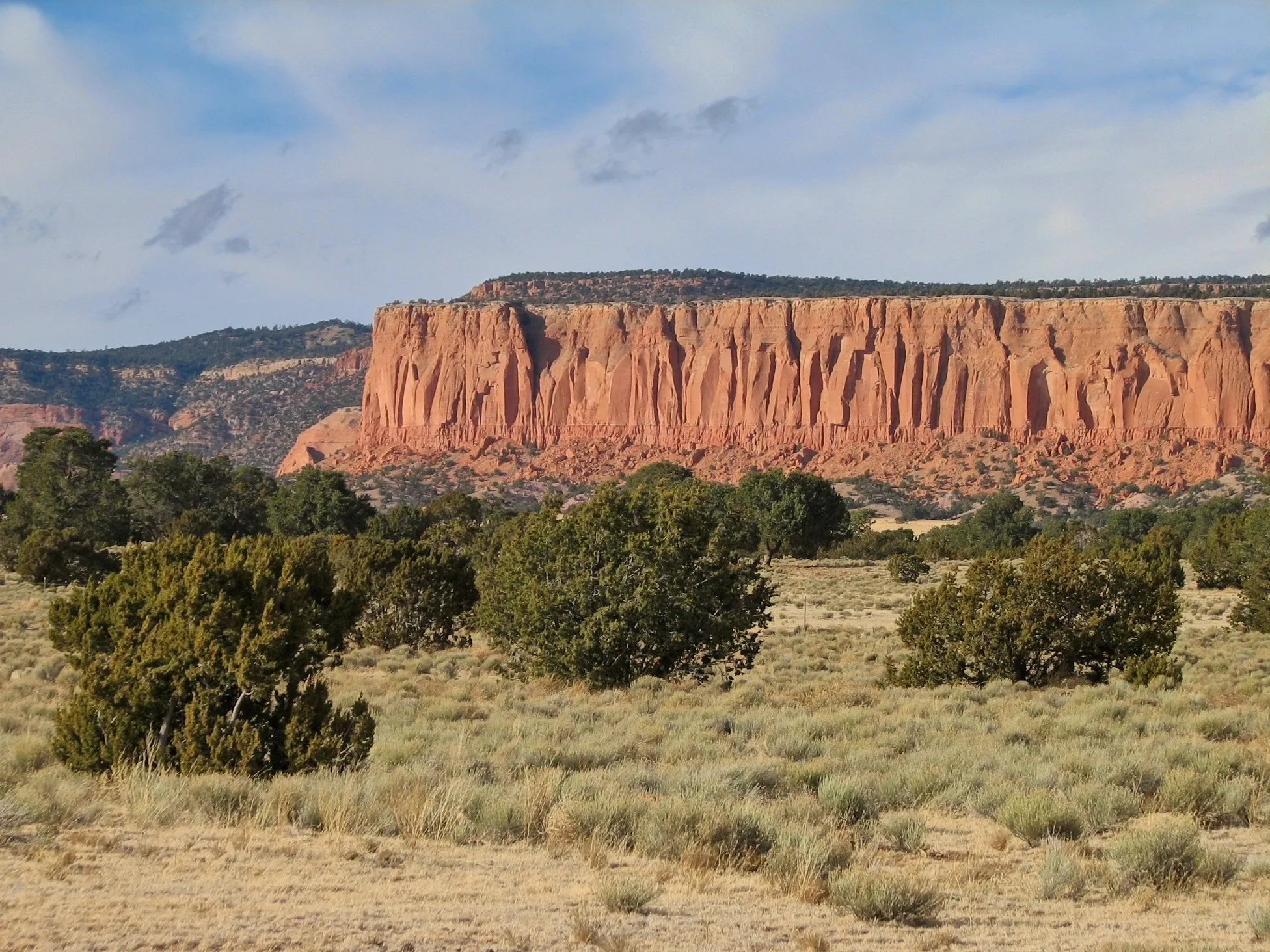 Red rock mesa with vertical erosion grooves at the Continental Divide, New Mexico.