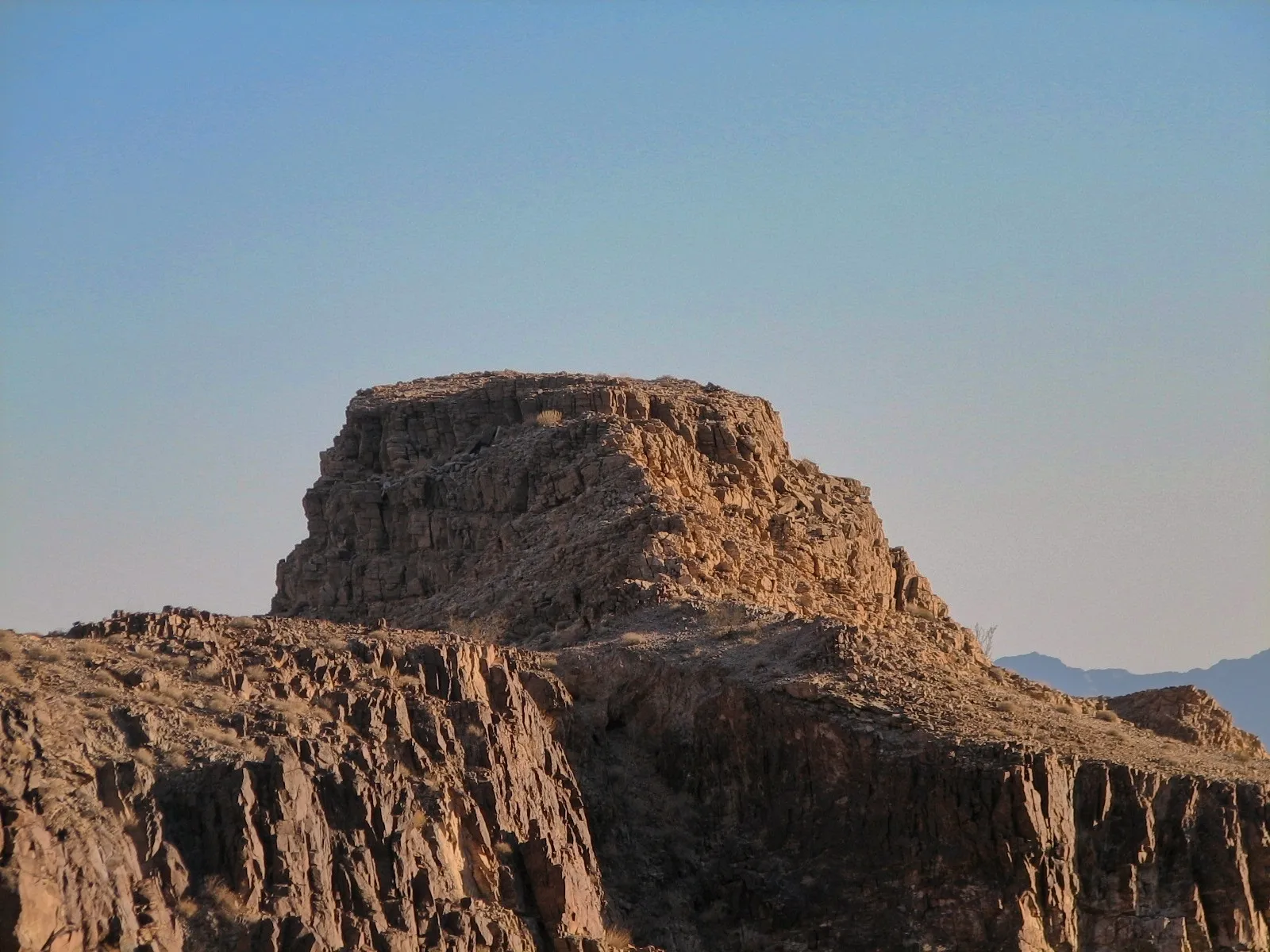 Flat-topped mesa with layered rock catching warm desert light, Colorado Desert.