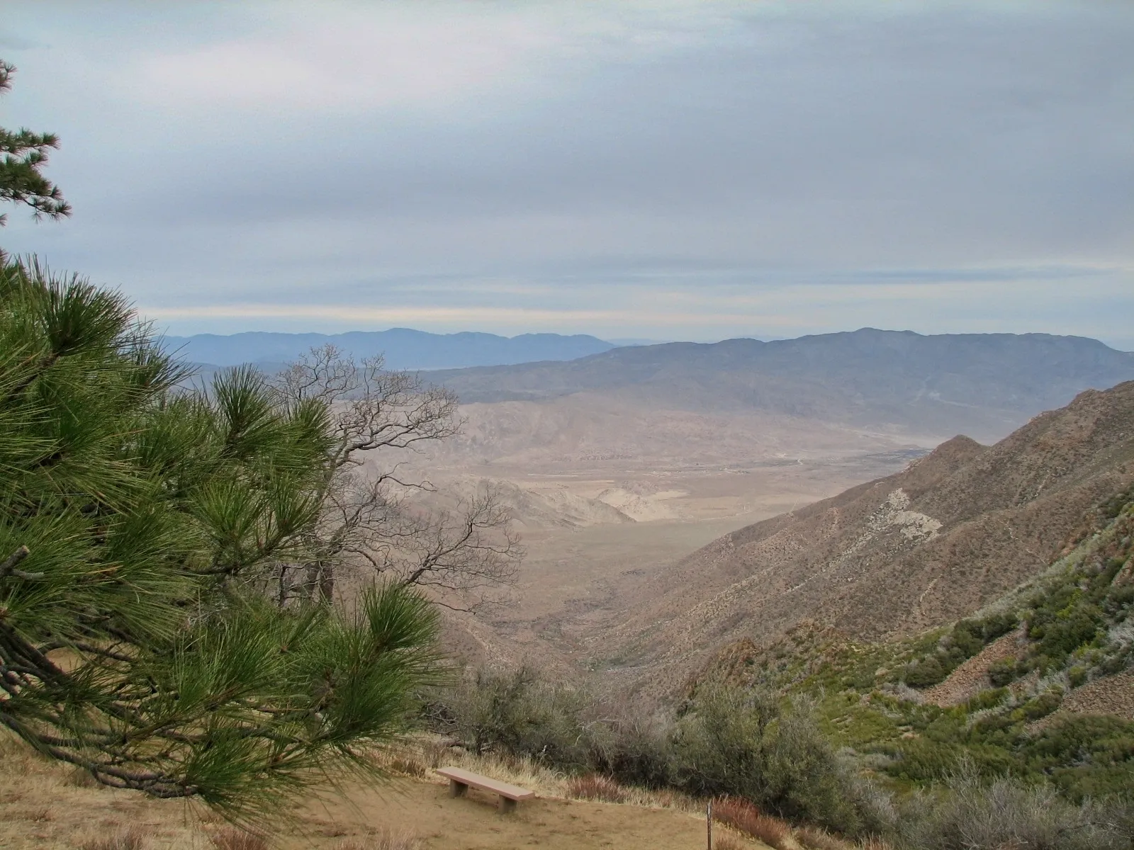 Wooden bench overlooking a canyon and desert basin from Mount Laguna, California.