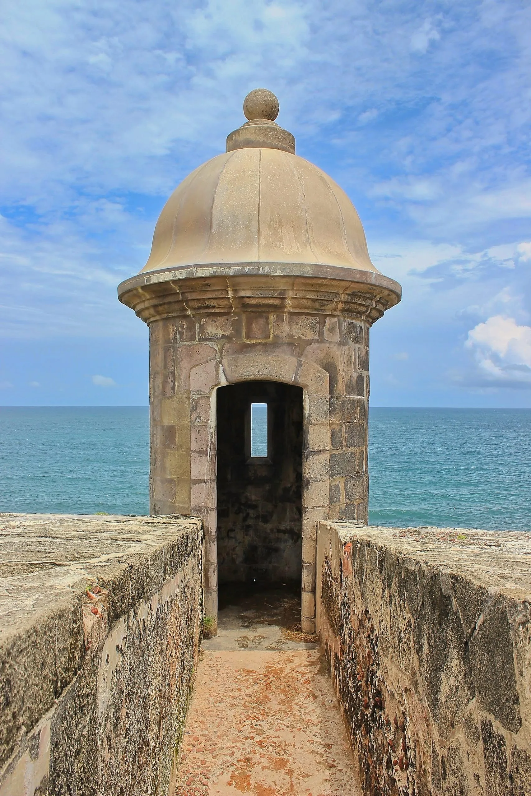 Stone sentry box at the end of a walkway overlooking the ocean at Castillo San Felipe del Morro, San Juan, Puerto Rico.