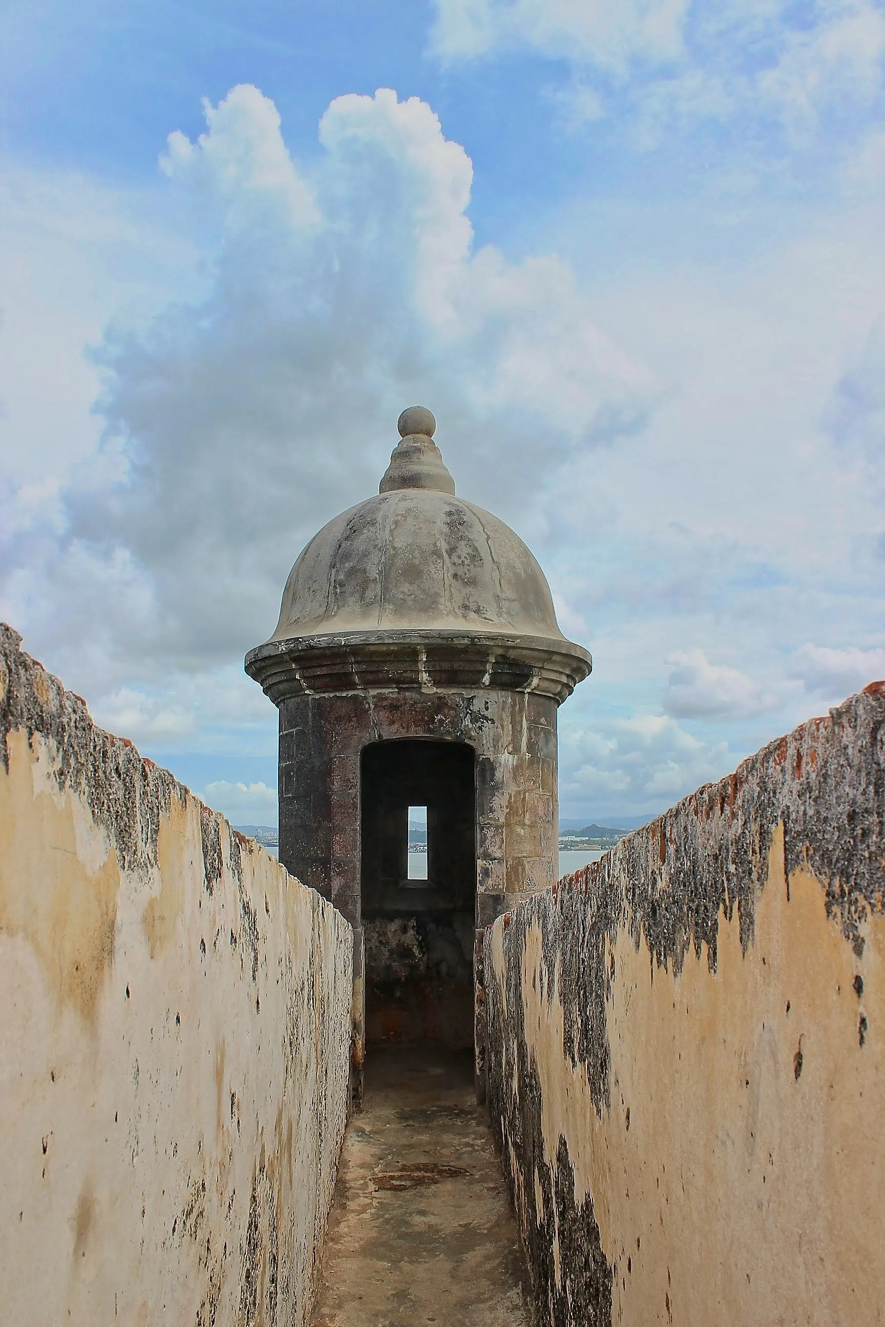 Stone sentry box at the end of a walkway overlooking the ocean at Castillo San Felipe del Morro, San Juan, Puerto Rico.